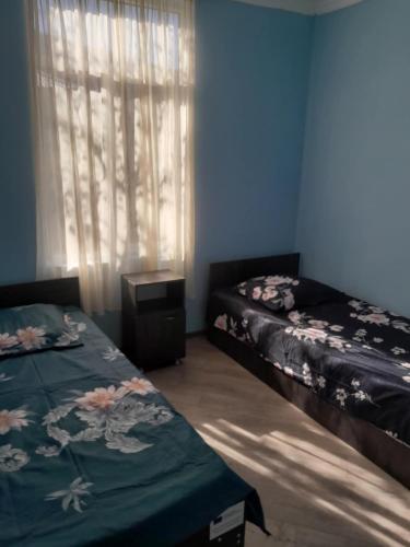 a bedroom with two beds and a window at Hotel Dede in Lentekhi