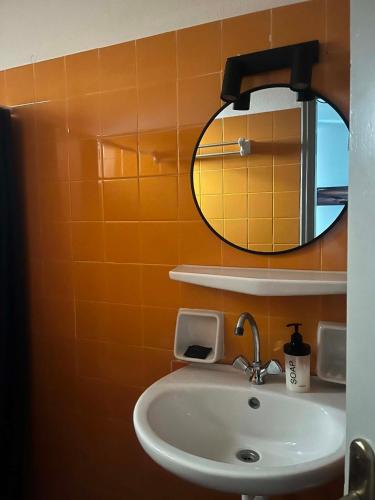 a bathroom with a sink and a mirror at Galini Pension in Ios Chora