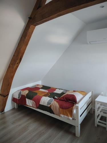 a bed in a room with a white wall at Jauxvial 1 in Jaux