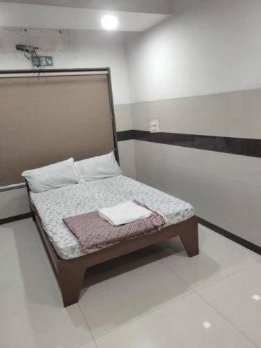 a small bed in a small room with at Balaji rooms&domentry in Surat