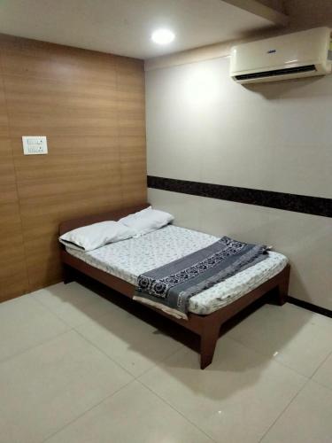 a small bedroom with a bed in a room at Balaji rooms&domentry in Surat