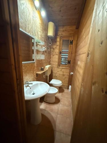 a bathroom with a sink and a toilet and a sink at Campeggio Il Delfino in Rocca Imperiale