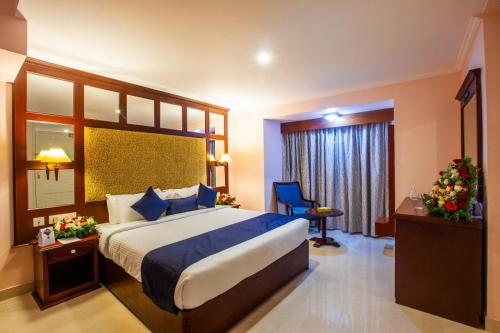 a hotel room with a large bed and a window at Holiday Hotel in Cherai Beach