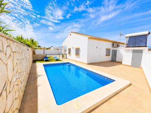 a swimming pool in the backyard of a villa at Chalet Playa Roche in Roche