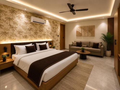a bedroom with a large bed and a living room at Velara Hotel & Banquet in Gwalior