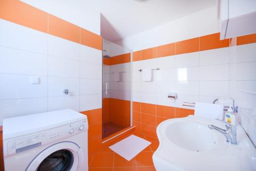 a bathroom with a washing machine and a washer at Villa Orange Peaceful Holiday Retreat in Zadar