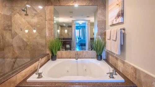 a bathroom with a tub with two potted plants at 123 Mariners Club in Key Largo