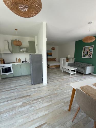 a kitchen and living room with a hardwood floor at Вила Солана - Villa Solana in Lozenets