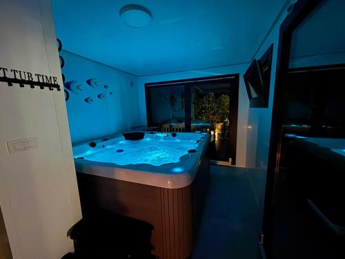 a bathroom with a large tub with blue lighting at Guest House Sidro - Wellness & Restaurant in Selce