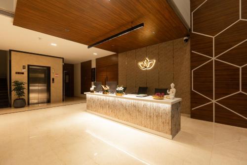 a lobby with a reception desk in a building at Grand Continent Hotel, Rameswaram in Rāmeswaram