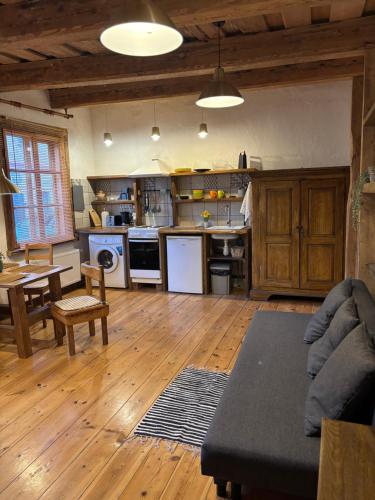 a kitchen with a couch and a table in a room at Central & Quiet Cēsis Stay in Cēsis