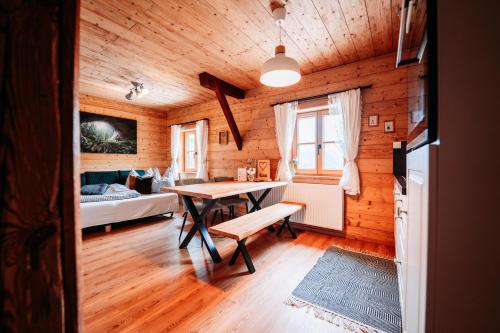 a wooden room with a table and a couch at Peer Alm in Navis