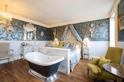 a bedroom with a bed and a bath tub in it at The Dial House in Reepham