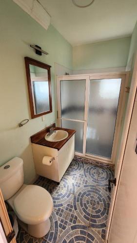 a bathroom with a toilet and a sink at Villa Patty by the beach in El Conacaste