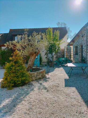 a backyard with a picnic table and a playground at Charmant gite en pierre in Gratot