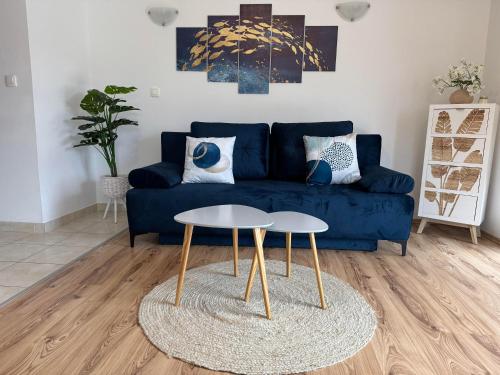 a living room with a blue couch and a table at Lorenzo apartment in Milna