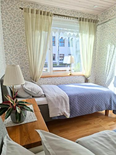 a bedroom with a bed and a window at Meie Hiiumaa majutus Kärdlas in Kärdla