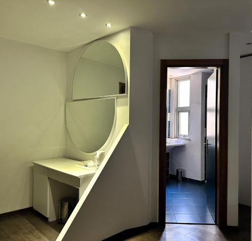 a bathroom with a sink and a mirror on the wall at Hotel Cristallo in Udine