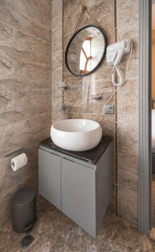 a bathroom with a sink and a mirror at The Destan Hotel and Terrace in Baku