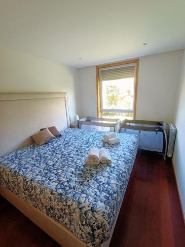 a bedroom with a bed with two shoes on it at Pacos Beach House in Lavra