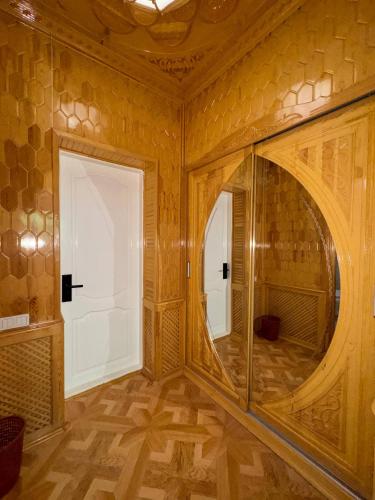 a room with a large mirror and a door at Turkiston Hotel in Namangan