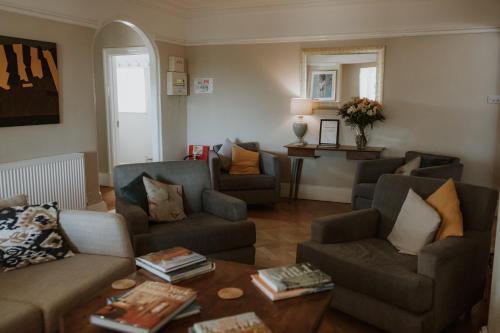 a living room with two couches and a table at Florence House Bed & Breakfast in Seaford