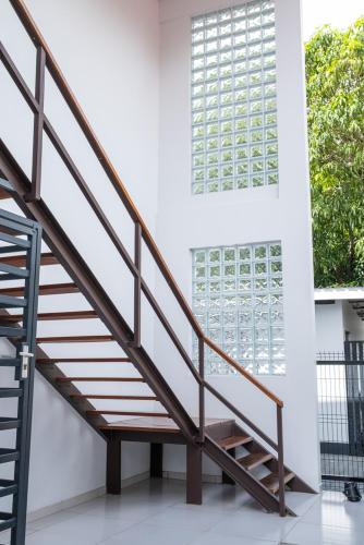 a wooden staircase in a house with a window at Bantaskine Apartments in Paramaribo