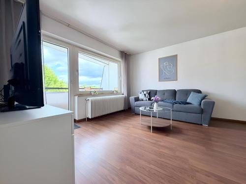a living room with a couch and a table at Über den Dächern von Borghorst - direktes Zentrum in Steinfurt