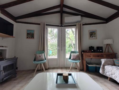 a living room with two chairs and a couch at Les 4 mousquetaires in Méjannes-le-Clap