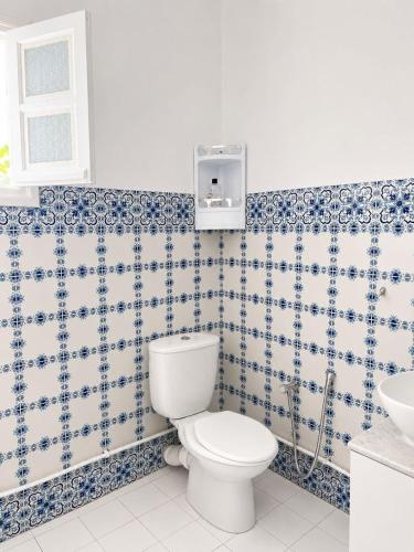 a bathroom with a toilet and a sink at La maison douce Bizerte in Bizerte