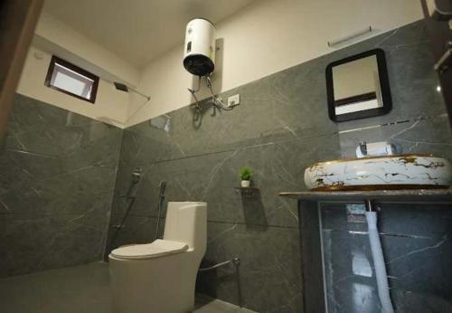 a bathroom with a toilet and a sink at Urbane Haauz in Pelling