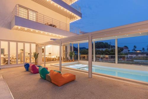 a house with a swimming pool and two chairs in front of it at Private Yangyang Dockchae Pool Villa in Yangyang