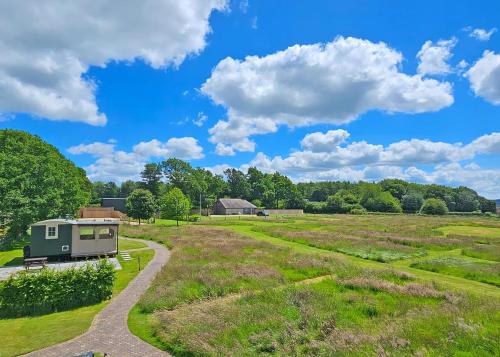 a tiny house in a field with a road at Hampshire Hills in Bighton
