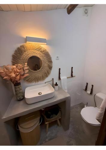 a bathroom with a sink and a mirror on a counter at Casa Tia Anica I in Monsaraz