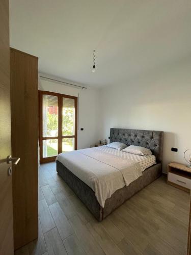 a bedroom with a large bed and a window at The quiet place in Hamallë