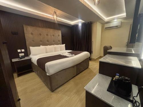 a bedroom with a large bed in a hotel room at Presken Hotel Mojidi, Allen Ikeja in Ikeja