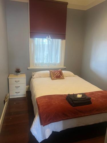 a small bedroom with a bed and a window at The Victoria Hotel in Collie