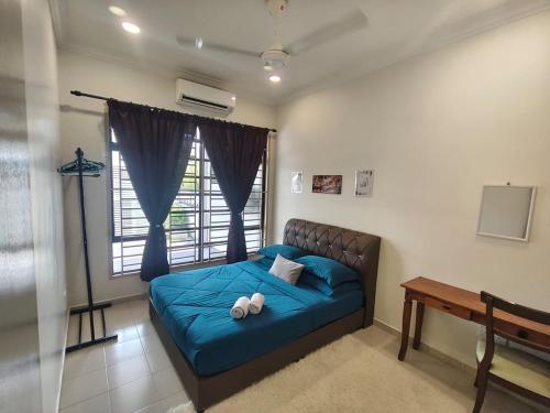a bedroom with a bed with blue sheets and a window at AA Homestay Bandar Mahkota Banting in Banting