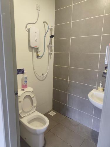 a bathroom with a white toilet and a sink at AA Homestay Bandar Mahkota Banting in Banting