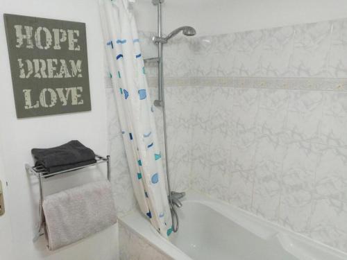 a bathroom with a shower and a white tub at Cottage Sleeps 2- Pet Friendly WiFi Free Parking in Montauriol