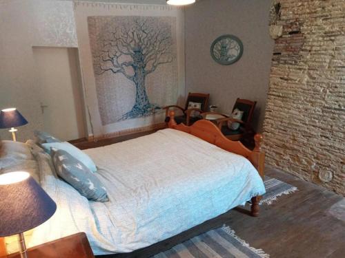 a bedroom with a bed with a tree painting on the wall at Cottage Sleeps 2- Pet Friendly WiFi Free Parking in Montauriol