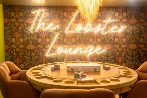 a room with a table and a sign that reads the dealer dance at Cape Cod heated Pool, Putting Green, Speak Easy, Game room, in Harwich