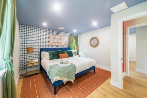 a bedroom with a bed with a blue headboard at Cape Cod heated Pool, Putting Green, Speak Easy, Game room, in Harwich