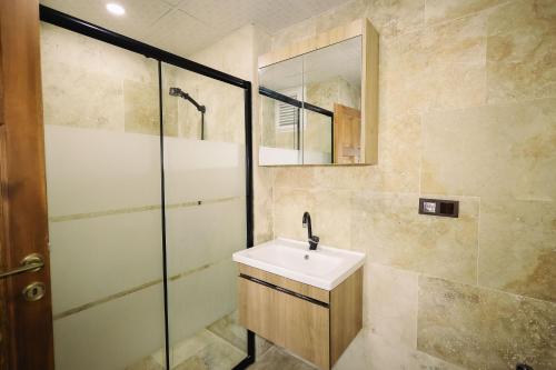 a bathroom with a sink and a shower at Castle Stone House in Uçhisar