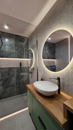 a bathroom with a sink and a shower at Jeziorna Premium Apartment in Siewierz
