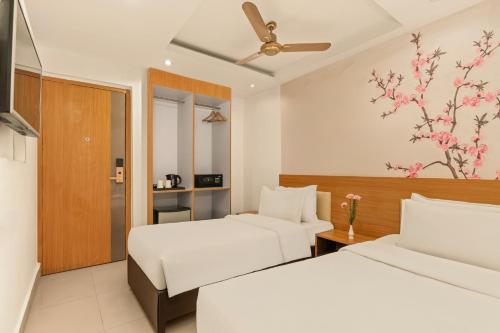 a hotel room with two beds and a window at Country Inn Smart Stays, Patna in Patna