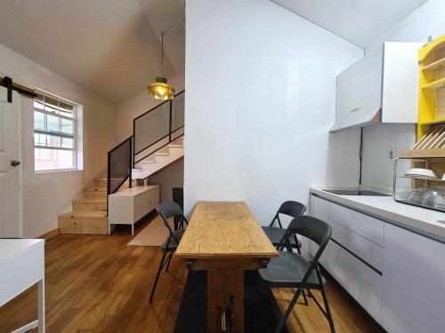 a kitchen with a table and chairs in a room at Goseong Maris Pension in Goseong
