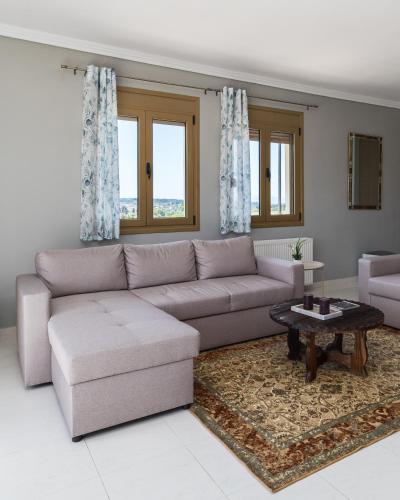 a living room with a couch and a table at Villa Granero by Booking Kottas in Kassandra
