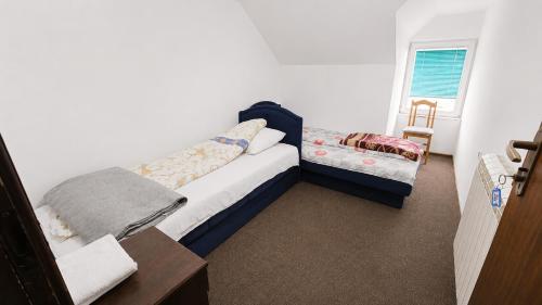 a small bedroom with a bed and a window at Motel MEČE in Bijelo Polje