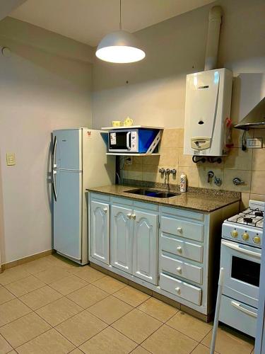 a kitchen with a refrigerator and a stove at OLÍMPICO in Concepción del Uruguay